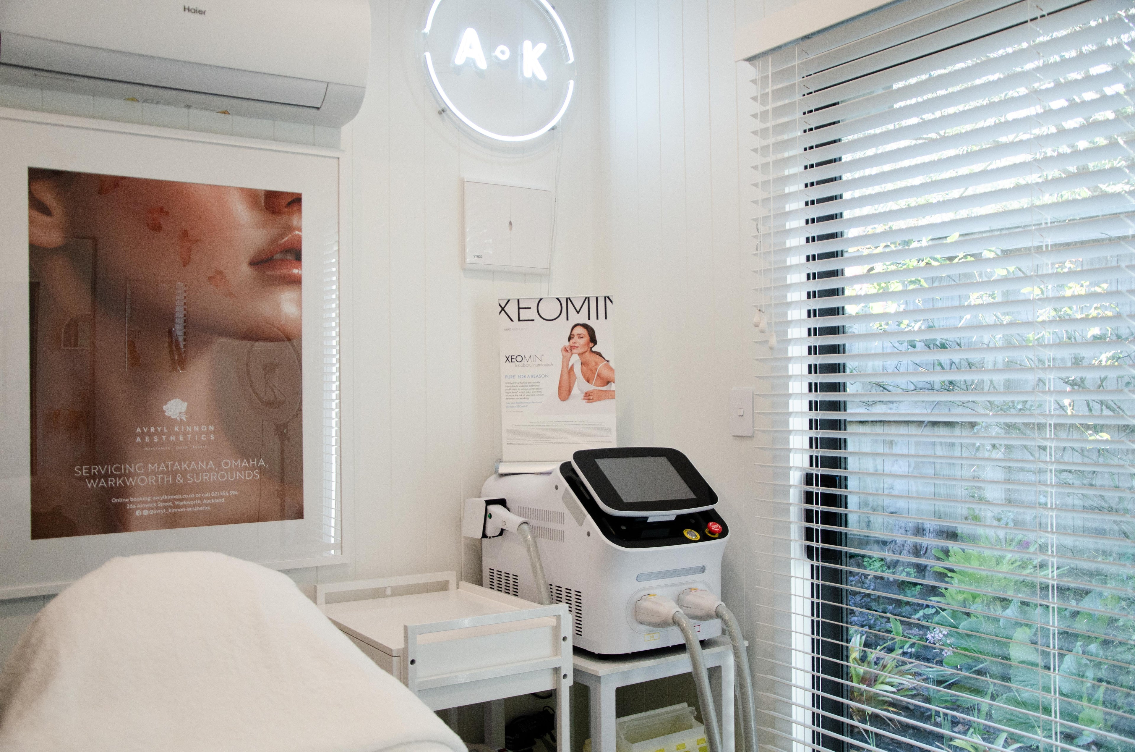 ONE OF THE TREATMENT ROOMS AT AVRYL KINNON AESTHETICS with skincare equipment and posters on the wall.