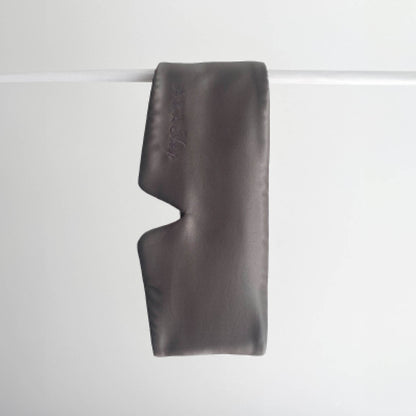 Slate Charcoal 100% Mulberry Silk Deep Sleep Eye Maks handing on a white rod with a white background
